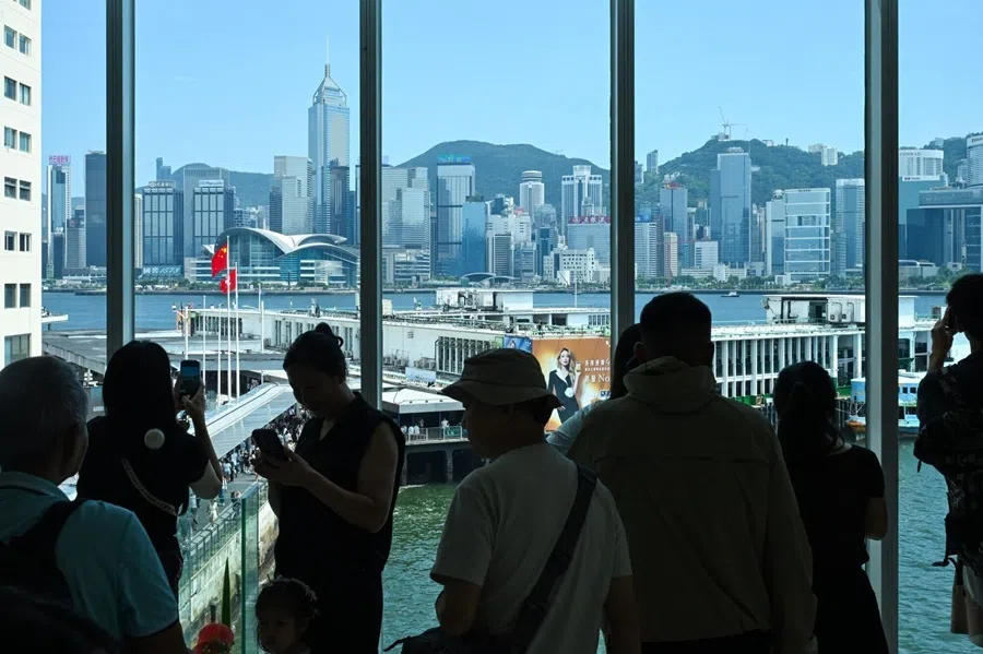 Visitors take in the view from the Tsim Sha Tsui area in Hong Kong, China, on 11 August 2026.