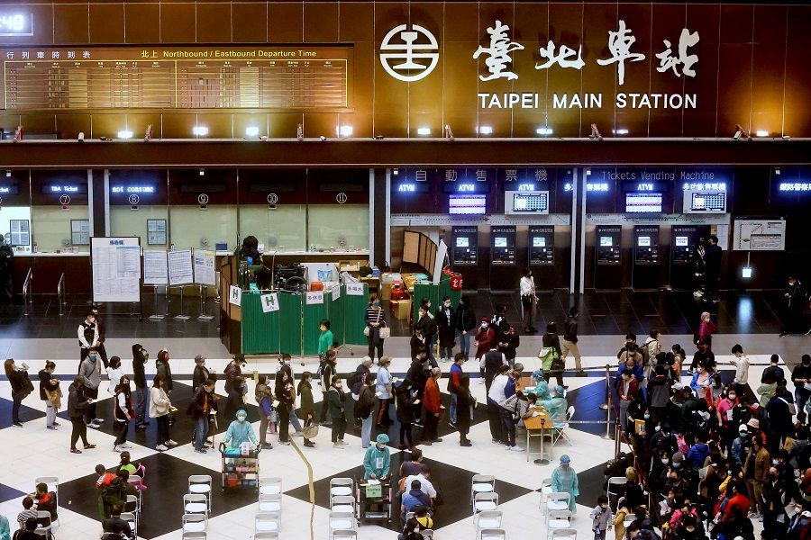 People wait to receive their Covid-19 booster shot at the lobby of Taipei main station ahead of Chinese New Year in Taipei, Taiwan, 24 January 2022. (Ann Wang/Reuters)