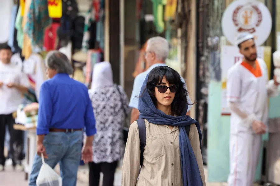 People walk on a market street in Tehran on 15 September 2024. (Atta Kenare/AFP)