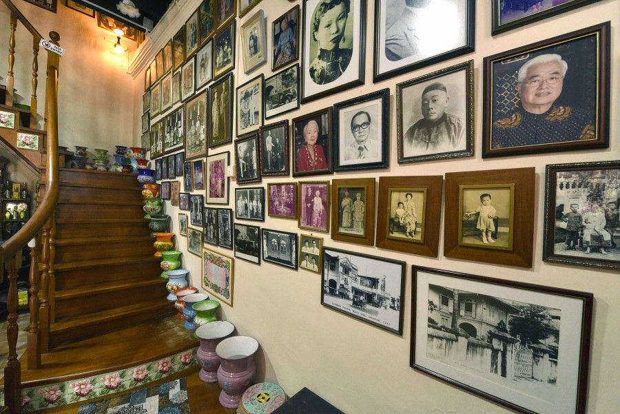 Colourful chamber pots and pictures of old Babas (Peranakan males) and Nyonyas (Peranakan females) line the right wall staircase in the second hall of Katong Antique House, a private museum, in a two-storey shophouse, and home to 100 years of Peranakan history, with antiques that date back to the 1800s. (SPH Media)