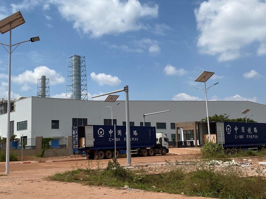 The Solarspace Technology (Laos) Co. in Saysettha Development Zone near Vientiane with trucks carrying containers (marked by the China Railway sign) bound for the Laos-China Railway's Vientiane South Station, Laos, on 22 October 2023. (Photo: Chen Xiangming)