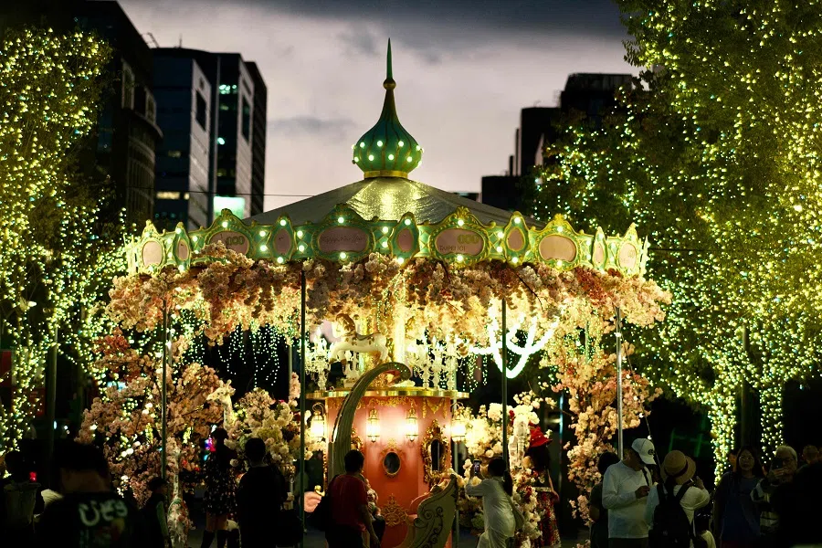 People gather as part of holiday festivities ahead of Christmas in front of the Taipei 101 commercial building in Taipei, Taiwan, on 14 December 2023. (Sam Yeh/AFP)
