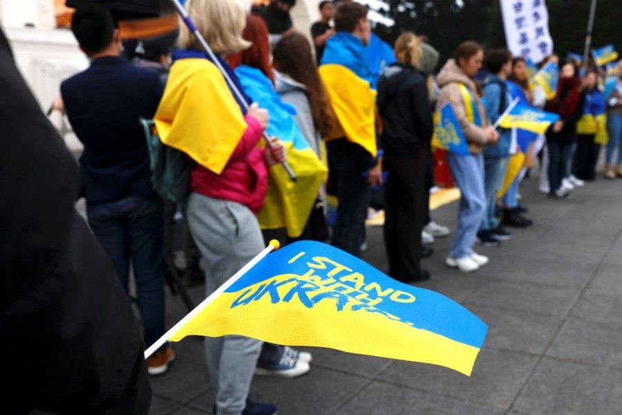 Activists hold a Ukrainian flag to show support to Ukraine to mark the one-year anniversary of Russia's invasion of Ukraine in Taipei, Taiwan, 25 February 2023. (Ann Wang/Reuters)