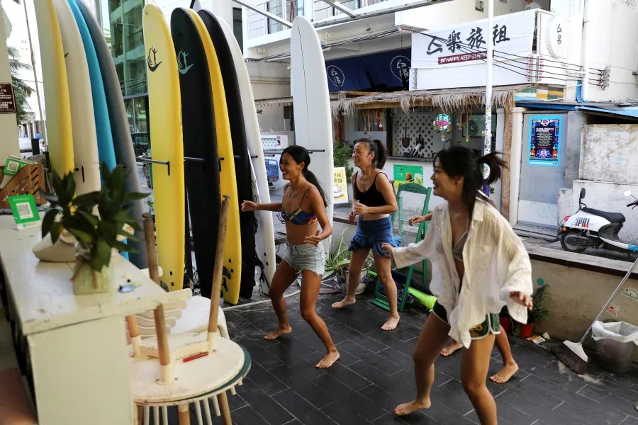 Women exercise during an online gym class at a surfing hotel in Houhai village in Sanya, Hainan province, China, 25 November 2020. (Tingshu Wang/REUTERS)