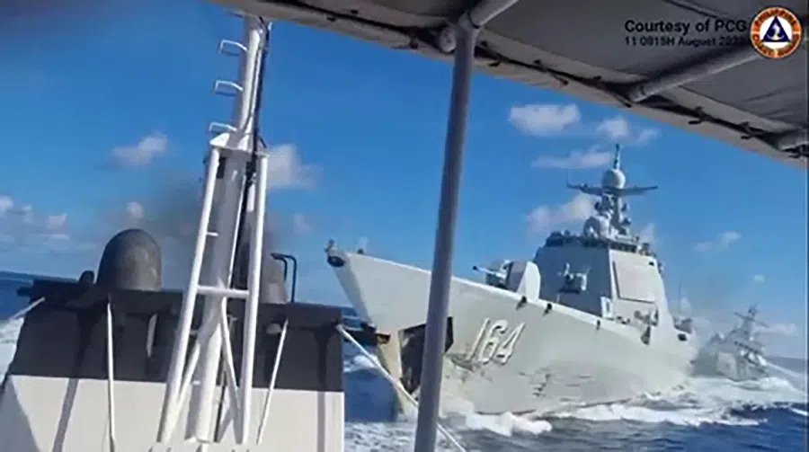 This handout video grab released and taken on 1 August 2025 by the Philippine Coast Guard shows a Chinese Navy vessel (right) following an incident with a Chinese Coast Guard ship (not seen), as viewed from a Philippine fisheries boat near Scarborough Shoal in the disputed South China Sea. (Handout/Philippine Coast Guard (PCG)/AFP)