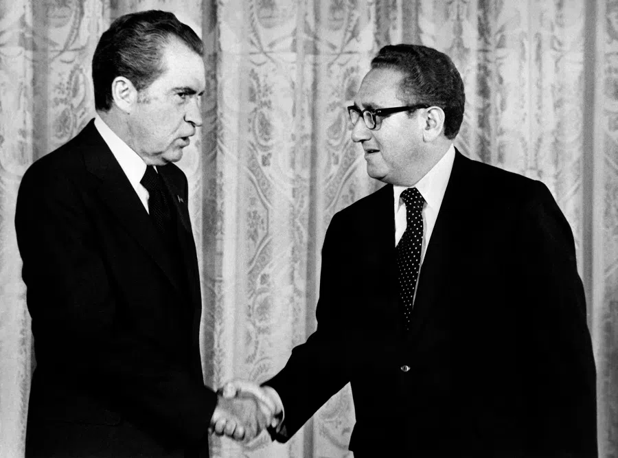 US President Richard Nixon (left) shakes hands with Henry Kissinger, the secretary of state, in September 1973 in Washington. (AFP)