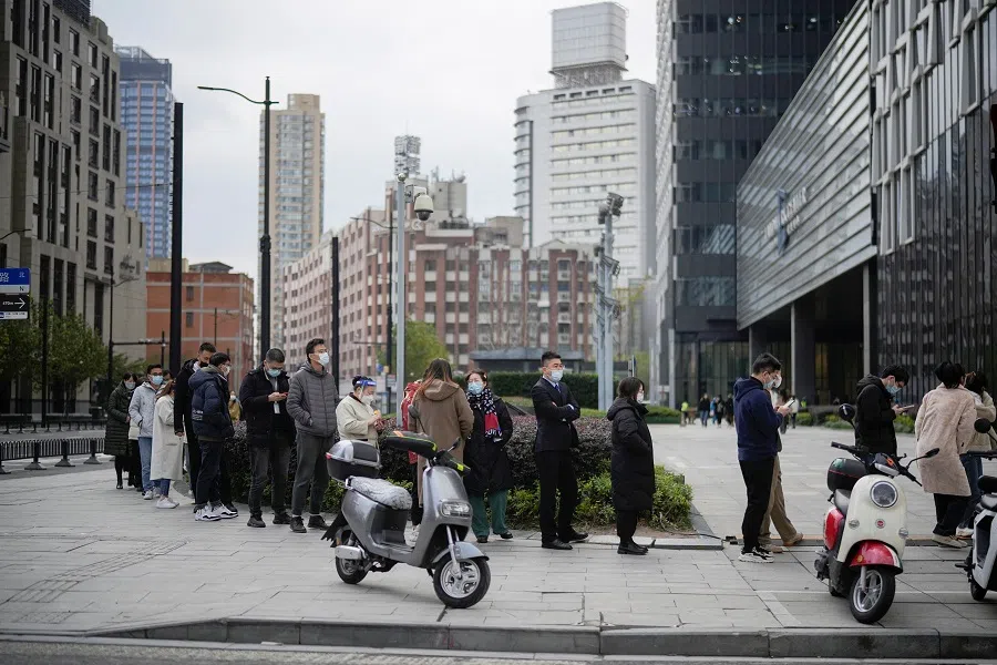 People line up to get tested for Covid-19 at a nucleic acid testing site, in Shanghai, China, 5 December 2022. (Aly Song/Reuters)
