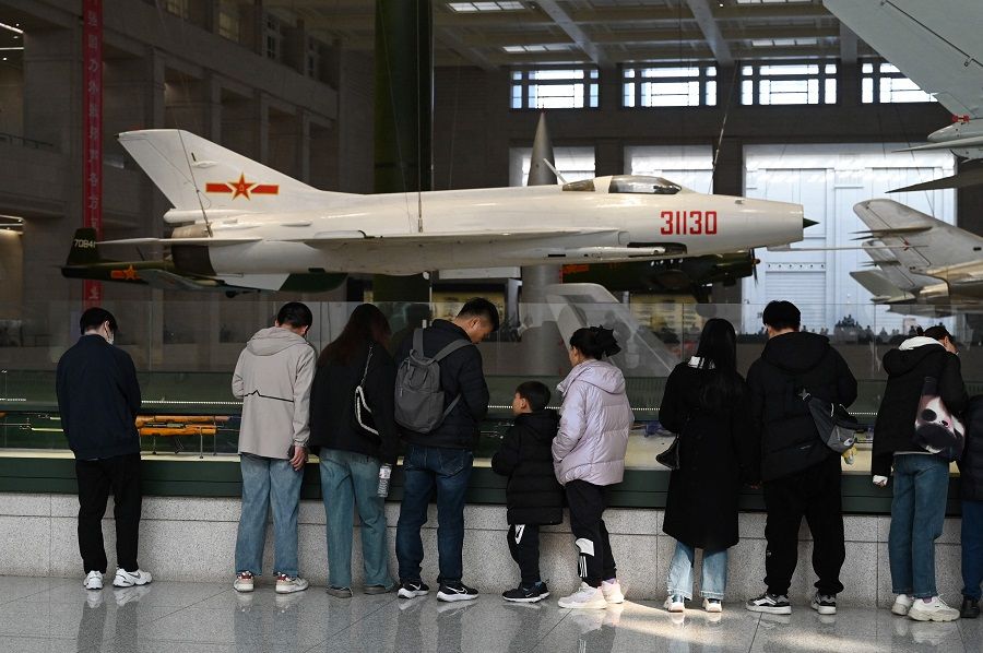 People look at Chinese fighter jets at the Military Museum in Beijing, China, on 3 March 2024. (Greg Baker/AFP)