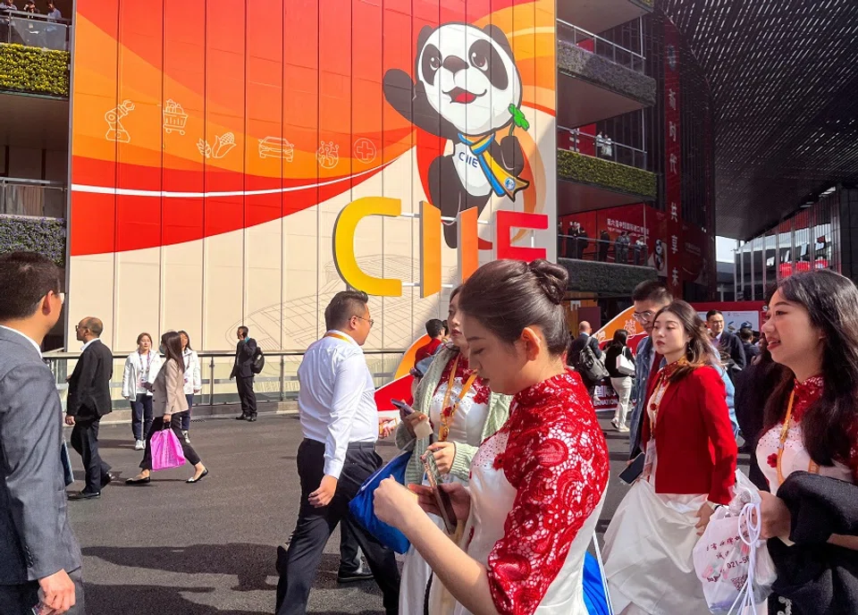 People walk at the venue of the China International Import Expo (CIIE) in Shanghai, China, 6 November 2023. (Casey Hall/Reuters)