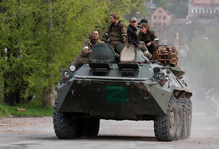 Service members of pro-Russian troops ride an armoured personnel carrier during fighting in Ukraine-Russia conflict near the Azovstal steel plant in the southern port city of Mariupol, Ukraine, 5 May 2022. (Alexander Ermochenko/Reuters)
