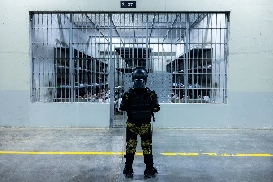 A Salvadoran army soldier watches alleged gang members inside a prison cell at the Terrorism Confinement Center (CECOT) prison, in this handout image obtained on 31 March 2025. (Secretaria de Prensa de la Presidencia/Handout via Reuters)