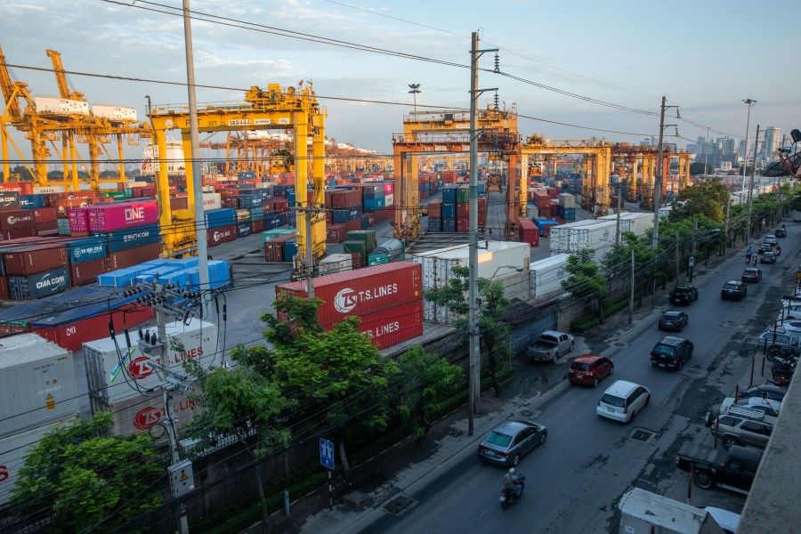 Vehicles travel past shipping containers and gantry cranes at the Bangkok Port in Bangkok, Thailand, 2 September 2020. (Taylor Weidman/Bloomberg)