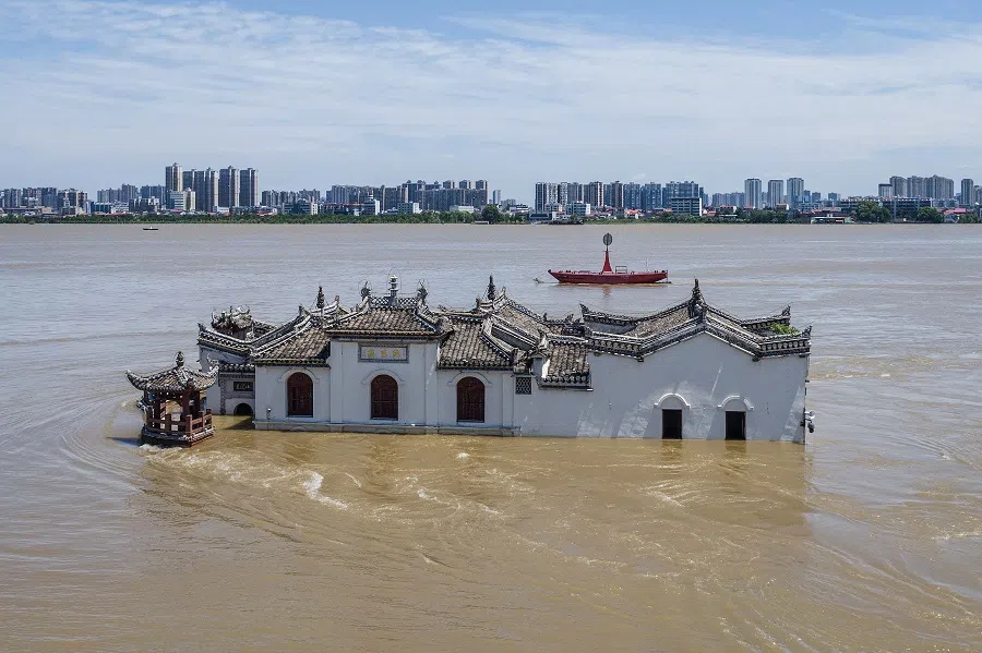 The photo taken on 6 July 2024 shows an aerial view of a partially submerged Guanyin temple in floodwaters in the swollen Yangtze River in Ezhou, central China’s Hubei province.