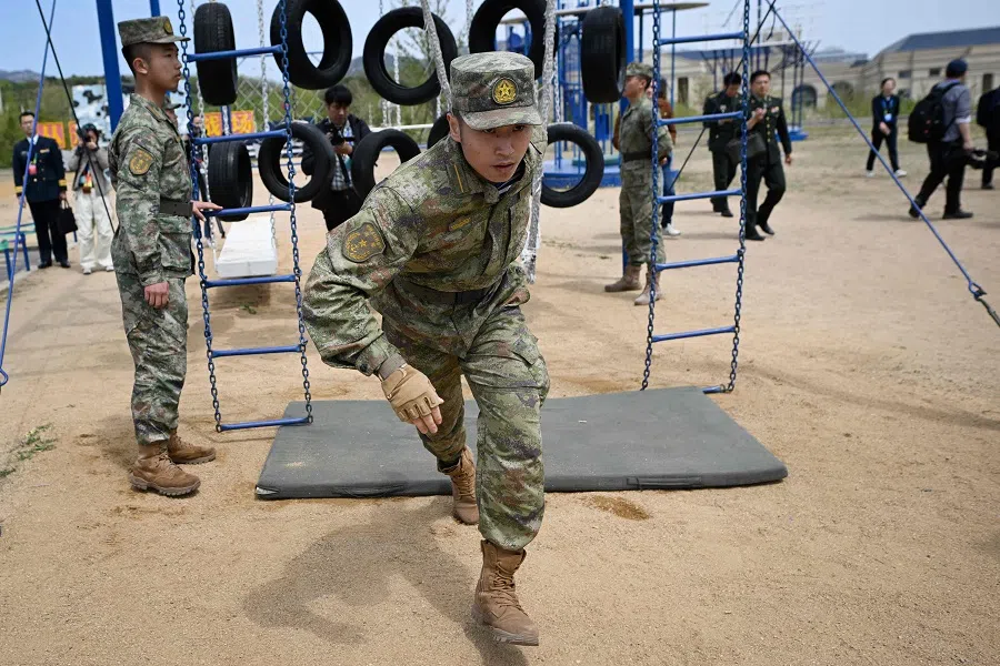 This picture taken during a media tour shows navy personnel demonstrating their training at the People’s Liberation Army Navy Submarine Academy during an open day to mark the navy’s 75th anniversary in Qingdao, China’s Shandong province, on 21 April 2024.  (Wang Zhao/AFP)