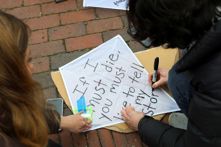 Demonstrators decorate a kite with a quote from Palestinian poet Refaat Alareer at a rally held by the Boston Coalition for Palestine calling for a permanent ceasefire in Gaza, amid the ongoing conflict between Israel and Hamas, in Boston, Massachusetts, US, on 17 December 2023. (Reba Saldanha/Reuters)