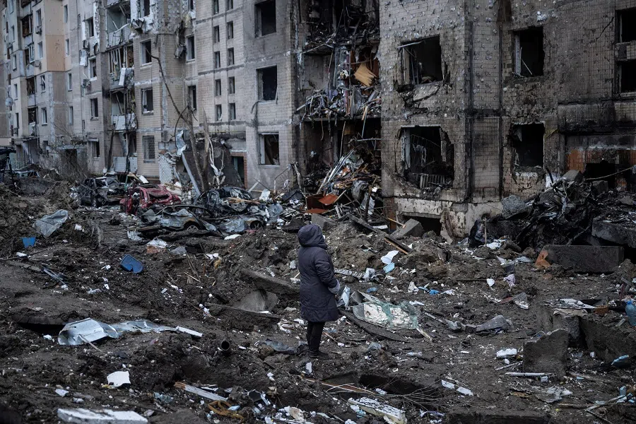 A woman looks at her apartment building heavily damaged by a Russian missile strike, amid Russia's attack on Ukraine, in Kyiv, Ukraine, on 2 January 2024. (Viacheslav Ratynskyi/Reuters)