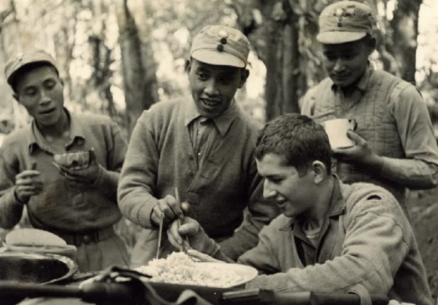 Chinese soldiers teaching Edward F. McNamara how to use chopsticks.
