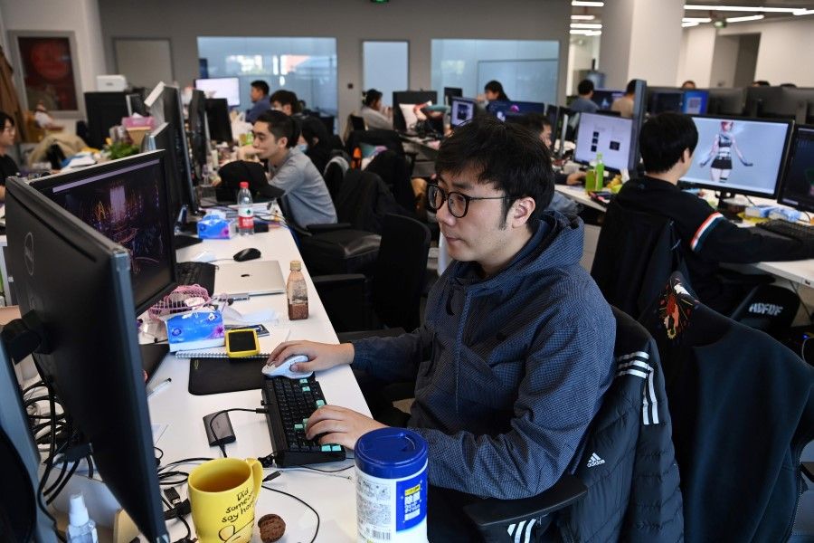 In this photo taken on 12 November 2020, animators work on designs for virtual idol Amy at the Beijing Mizhi Tech offices in Beijing. (Greg Baker/AFP)