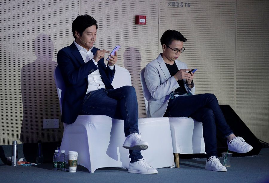 Xiaomi founder and CEO Lei Jun (L) waiting to attend a product launch event of Xiaomi Mi9 Pro 5G and Mi MIX Alpha concept smartphone in Beijing in September 2019 (Jason Lee/Reuters)