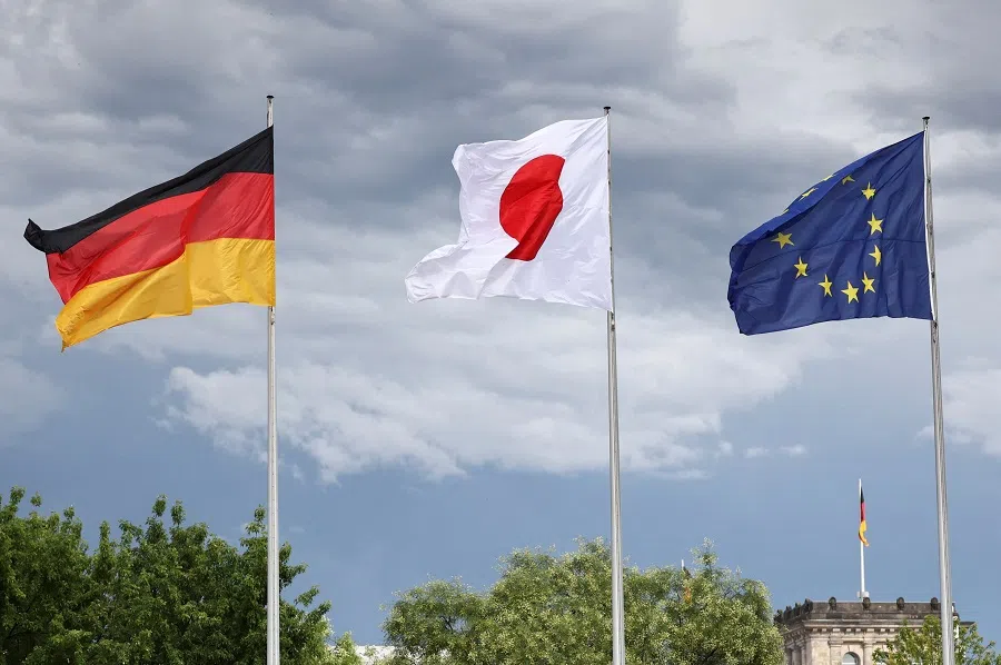 The flags of Germany, Japan and the European Union fly on the day German Chancellor Olaf Scholz receives Japanese Prime Minister Fumio Kishida with military honours in Berlin, Germany, 12 July 2024. (Liesa Johannssen/Reuters)