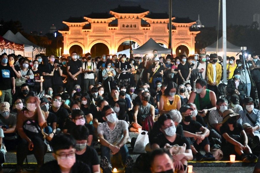 People take part in a vigil on the 33rd anniversary of the 1989 Tiananmen Square pro-democracy protests and crackdown, at the Chiang Kai-shek Memorial Hall in Taipei on 4 June 2022. (Sam Yeh/AFP)