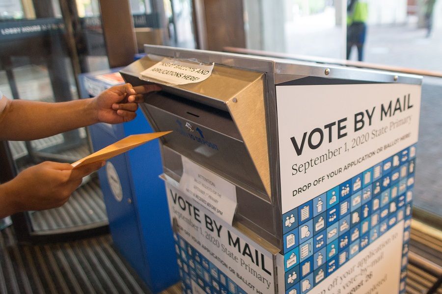A voter casts their ballot at a vote by mail dropbox at Boston City Hall in Boston, Massachusetts, US, on 1 September 2020. (Scott Eisen/Bloomberg)