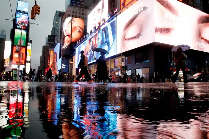 People walk through Times Square in New York City on 18 January 2025. (Leonardo Munoz/AFP)