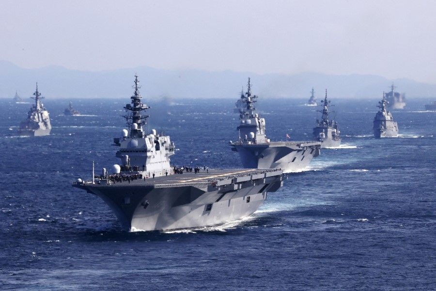 An aerial view shows Japan's Maritime Self-Defense Force (JMSDF)'s multi-purpose destroyer Izumo (DDH-183) leading the fleet during the International Fleet Review to commemorate the 70th anniversary of the foundation of the JMSDF, at Sagami Bay, off Yokosuka, south of Tokyo, Japan, 6 November 2022. (Kyodo/via Reuters)