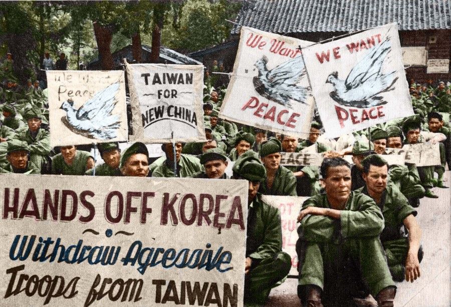 US POWs in Korea holding up anti-war slogans, 1951. While the American POWs were well-treated, they also went through ideological education, which got them protesting against US policies.