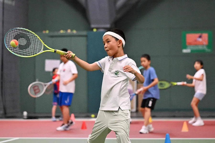 Children practice tennis at a club in Beijing on 14 August 2024. (Adek Berry/AFP)