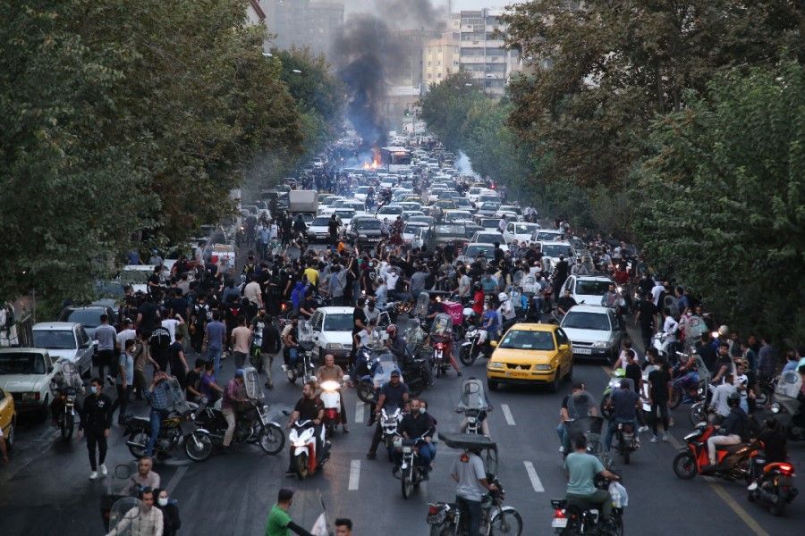 A picture obtained by AFP outside Iran on 21 September 2022, shows Iranian demonstrators taking to the streets of the capital Tehran during a protest for Mahsa Amini, days after she died in police custody. (AFP)