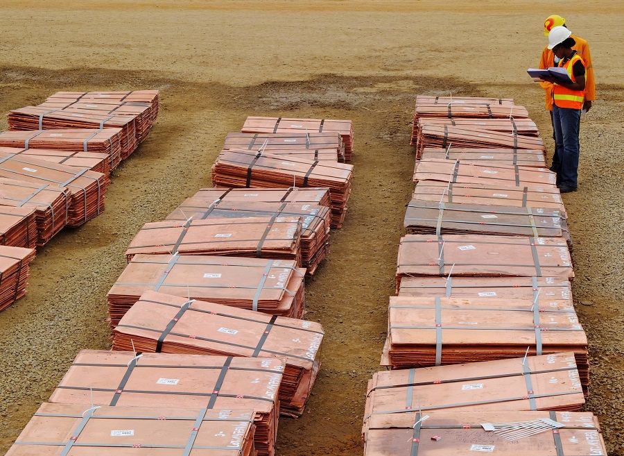 Workers at Tenke Fungurume, a copper mine in Katanga, Democratic Republic of Congo, check bundles of copper cathode sheets ready to be loaded and sent out to buyers, 29 January 2013. (Jonny Hogg/File Photo/Reuters)