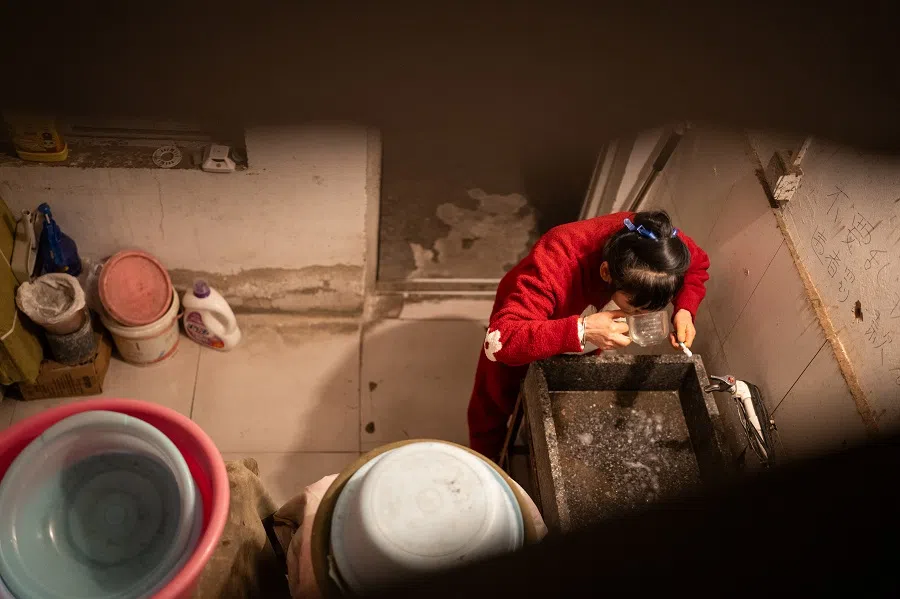 Sister Chen in the common wash area of her rented lodgings.