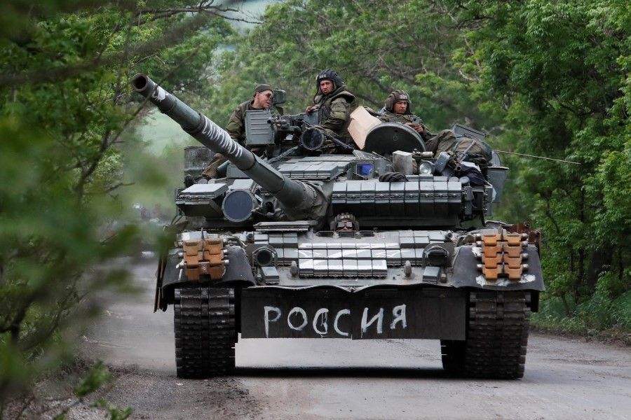 Service members of pro-Russian troops drive a tank during Ukraine-Russia conflict in the Donetsk Region, Ukraine, 22 May 2022. The writing on the tank reads: "Russia". (Alexander Ermochenko/Reuters)