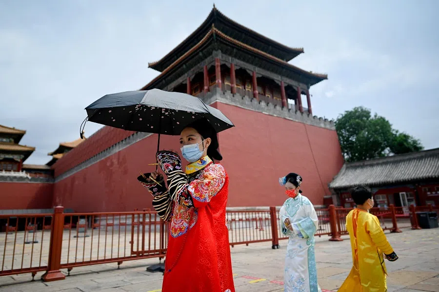 People wearing the Chinese tranditional dress, known as Hanfu, prepare to visit the Forbidden City in Beijing, China, on 7 June 2022. (Wang Zhao/AFP)