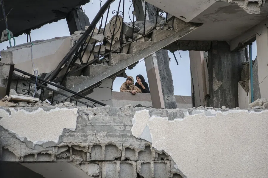 Palestinians look at the damage to a mosque following an Israeli airstrike, in Deir al-Balah, central Gaza, on 6 October 2024. (Ahmad Salem/Bloomberg)