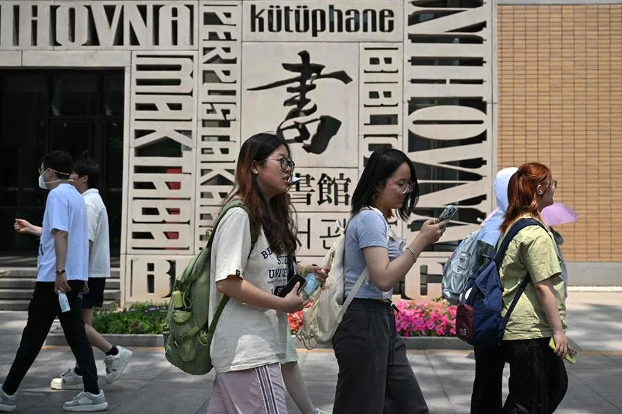 This file photo taken on 29 May 2025 shows Chinese students walking at Beijing Foreign Studies University in Beijing.