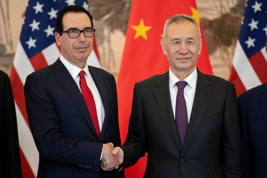 China’s Vice-Premier Liu He gestures next to US Treasury Secretary Steven Mnuchin as they pose for a group photo at Diaoyutai State Guesthouse in Beijing, China, on 29 March 2019. (Nicolas Asfouri/Pool via Reuters)