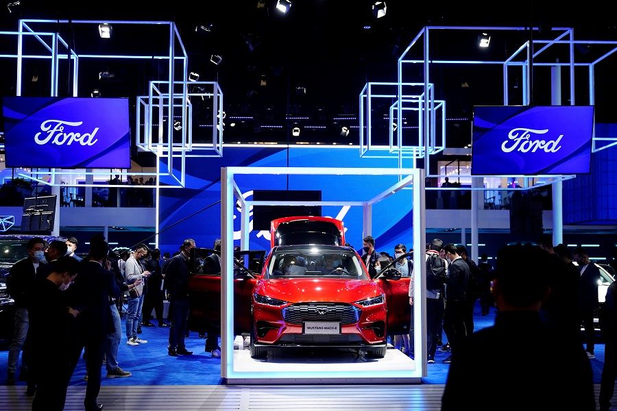 Visitors check a Ford Mustang Mach-E electric vehicle (EV) displayed at the Ford booth during a media day for the Auto Shanghai show in Shanghai, China, 19 April 2021. (Aly Song/Reuters)