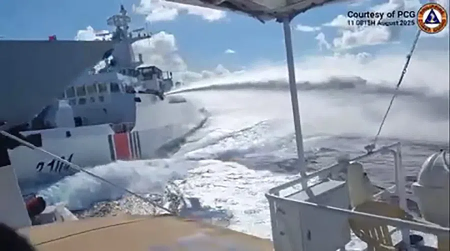 This handout video grab released and taken on 11 August 2025 by the Philippine Coast Guard shows an incident between a Chinese Navy vessel (far left, bow pictured) and a Chinese Coast Guard ship (second from left) as seen from a Philippine fisheries boat near Scarborough Shoal in the disputed South China Sea.