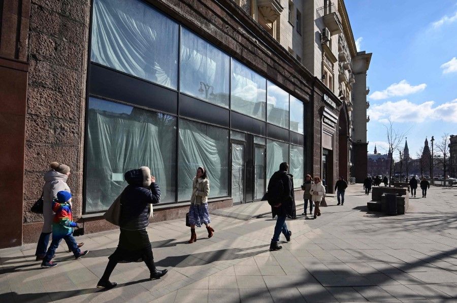 People walk past empty retail space on Tverskaya street in central Moscow on 16 March 2022. (AFP)