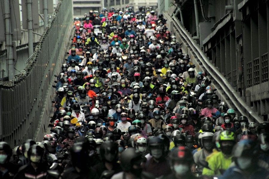 Motorcyclists ride down the congested exit of the Taipei bridge during rush hour on 6 August 2021. (Sam Yeh/AFP)