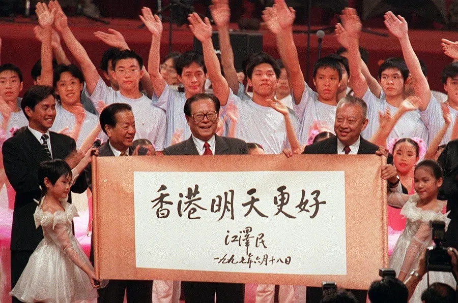 Chinese President Jiang Zemin (centre) shares centre stage with Hong Kong Chief Executive Tung Chee-hwa (centre right) and Chinese Foreign Minister Qian Qichen (centre left) during the finale of the official celebration ceremony in Hong Kong on 1 July 1997.
