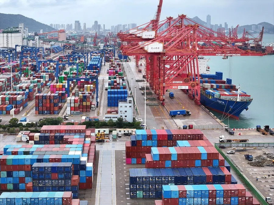 A drone view shows a cargo ship and shipping containers at the port of Lianyungang in Jiangsu province, China, on 17 October 2024. (China Daily via Reuters)