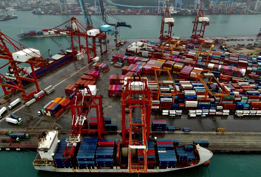 This aerial photograph taken on 8 December 2020 shows a cargo ship (bottom) being loaded with containers at the harbour in Keelung, Taiwan. (Sam Yeh/AFP)