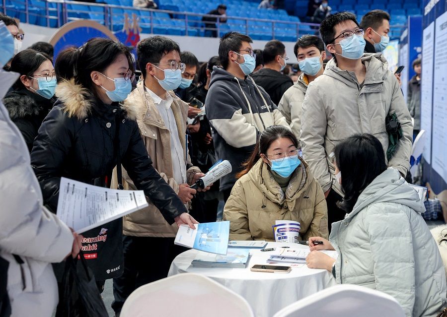 Job seekers approach the booth of an employer at a job fair in Wuhan, Hubei province, China, 9 February 2023. (CNS photo via Reuters)