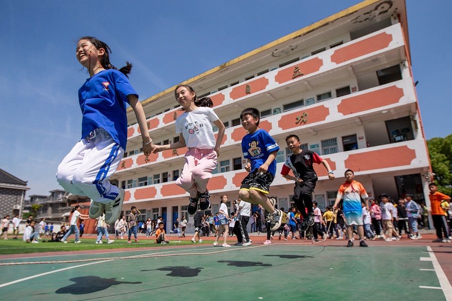 Elementary school students play on Children's Day in Hai'an, Jiangsu province, China on 1 June 2021. (STR/AFP)
