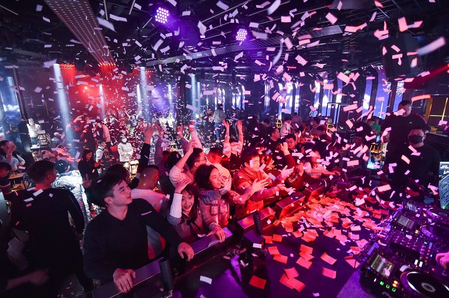 People celebrate the new year at a bar in Nanjing, Jiangsu province, China, on 1 January 2023. (AFP)