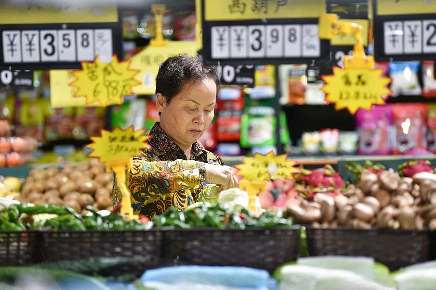 A customer shops at a supermarket in Nanjing, Jiangsu province, China, on 13 October 2023. (AFP)