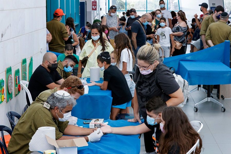Israeli children undergo Covid-19 antibody testing in the coastal city of Netanya, Israel, on 22 August 2021, before the start of the new school year. (Jack Guez/AFP)